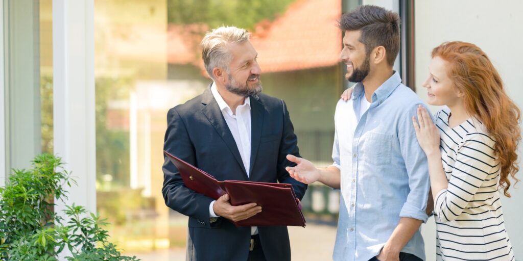 Real estate attorney in South Florida reviewing property purchase documents with clients in Broward County.