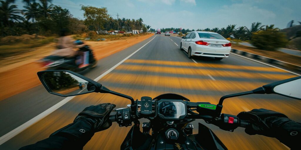 First-person perspective of a rider on a motorcycle navigating traffic on a South Florida highway.