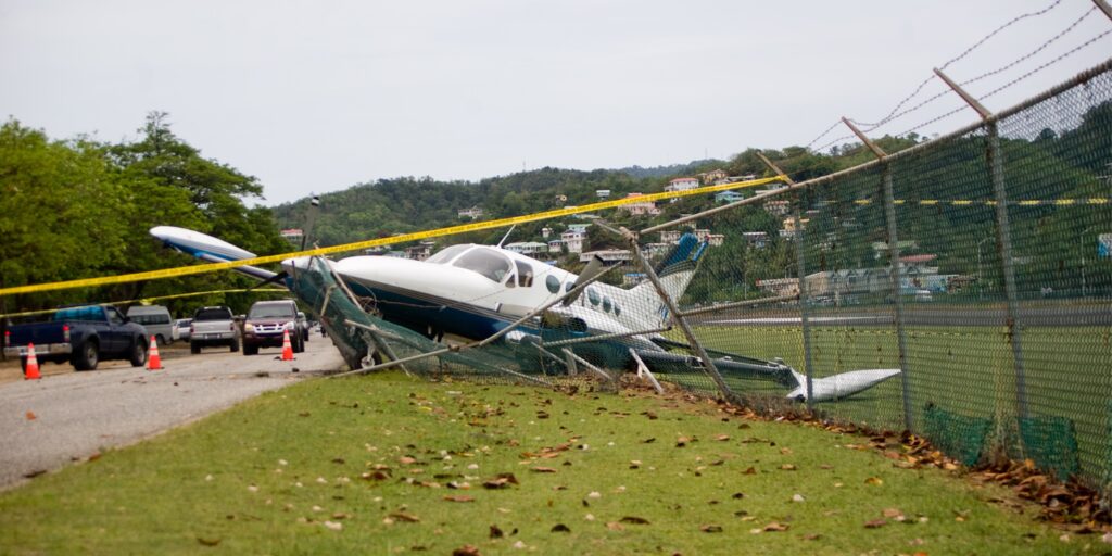 Small aircraft crashed through a security fence at an airport